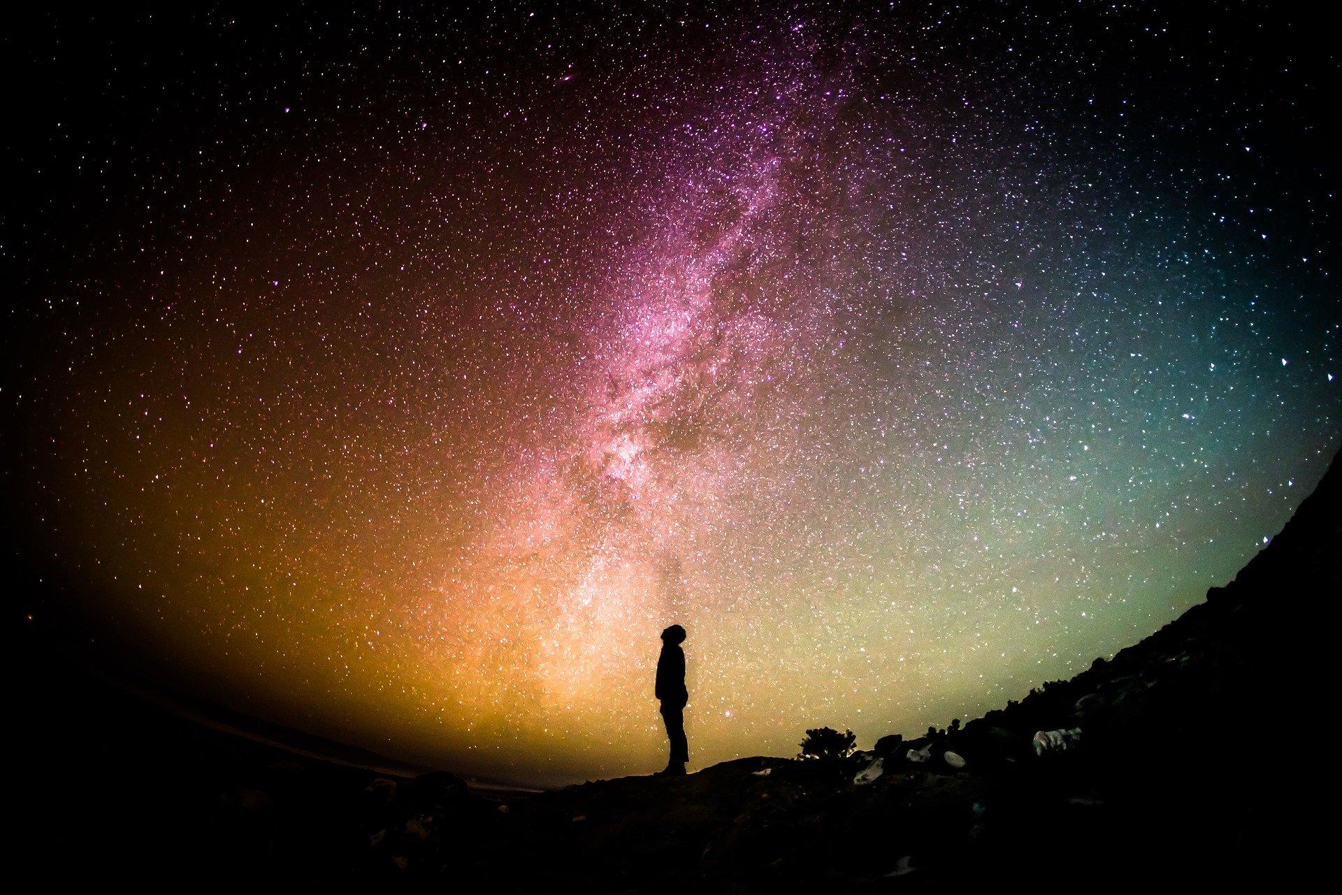 Person standing under a starry sky